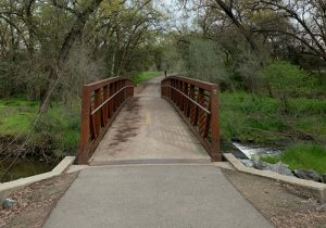 bridge leading to a park over a river